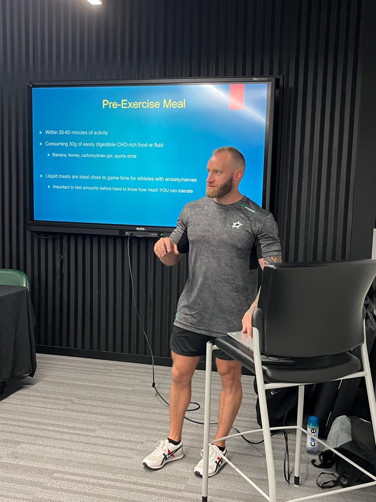 Jace presenting a fueling strategy to Dallas Stars players